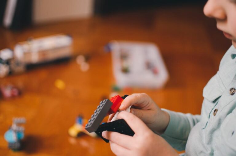 Young child building with colorful toy bricks, showing play and learning in early development