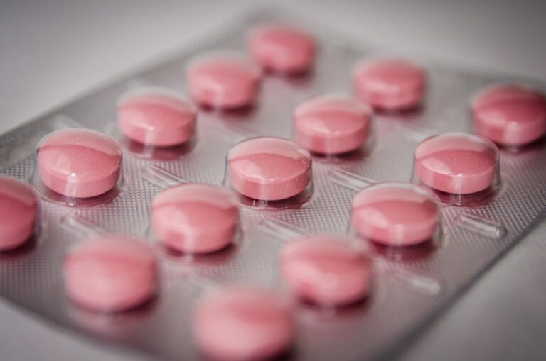 Close-up of pink tablets in a blister pack, representing hormonal birth control options
