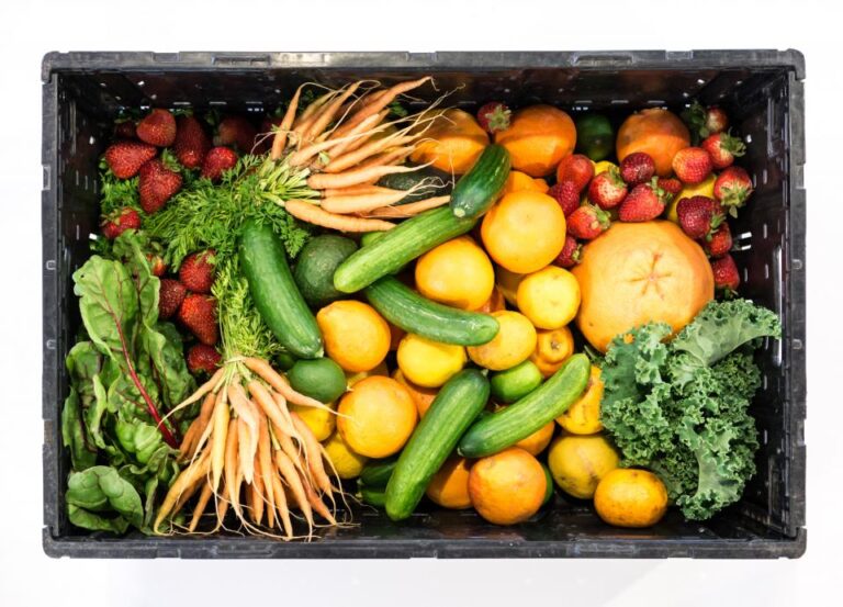 Crate of fresh carrots, cucumbers, citrus, strawberries and kale, a simple daily habit for long-term health