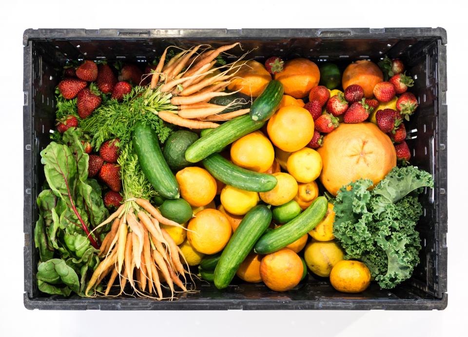 Crate of fresh carrots, cucumbers, citrus, strawberries and kale, a simple daily habit for long-term health