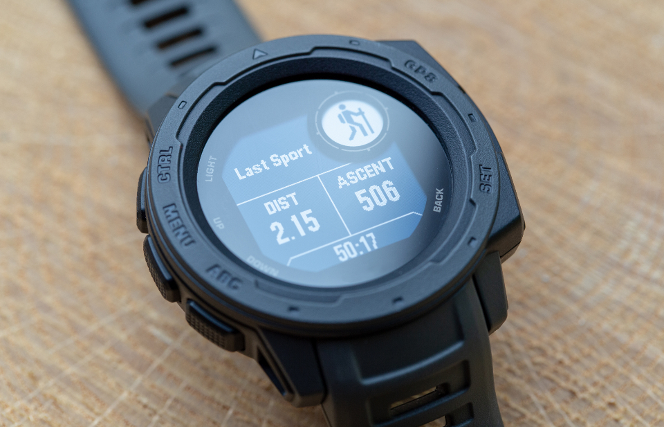 Close-up of a GPS sports watch showing distance and ascent, illustrating the data a fitness tracker records